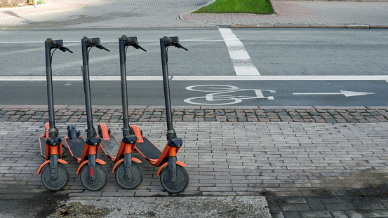 Riga, Latvia - November 30, 2019 : Shared rental electric scooters next parked next to the bicycle road, new trendy gadget for urban young people lifestyle
