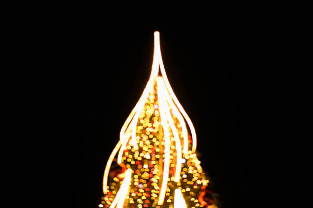 istock Blurred christmas tree background with orange lights. 1192350915