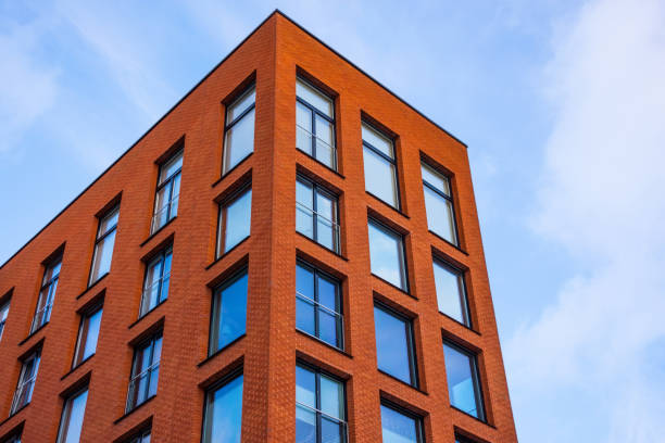 istock View of a new residential rectangular modern red brick house with classic windows. 1192351726