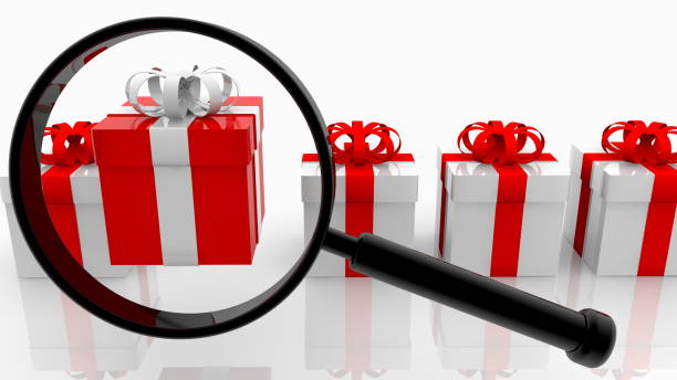 istock Magnifying glass on row of gift boxes 1192352524