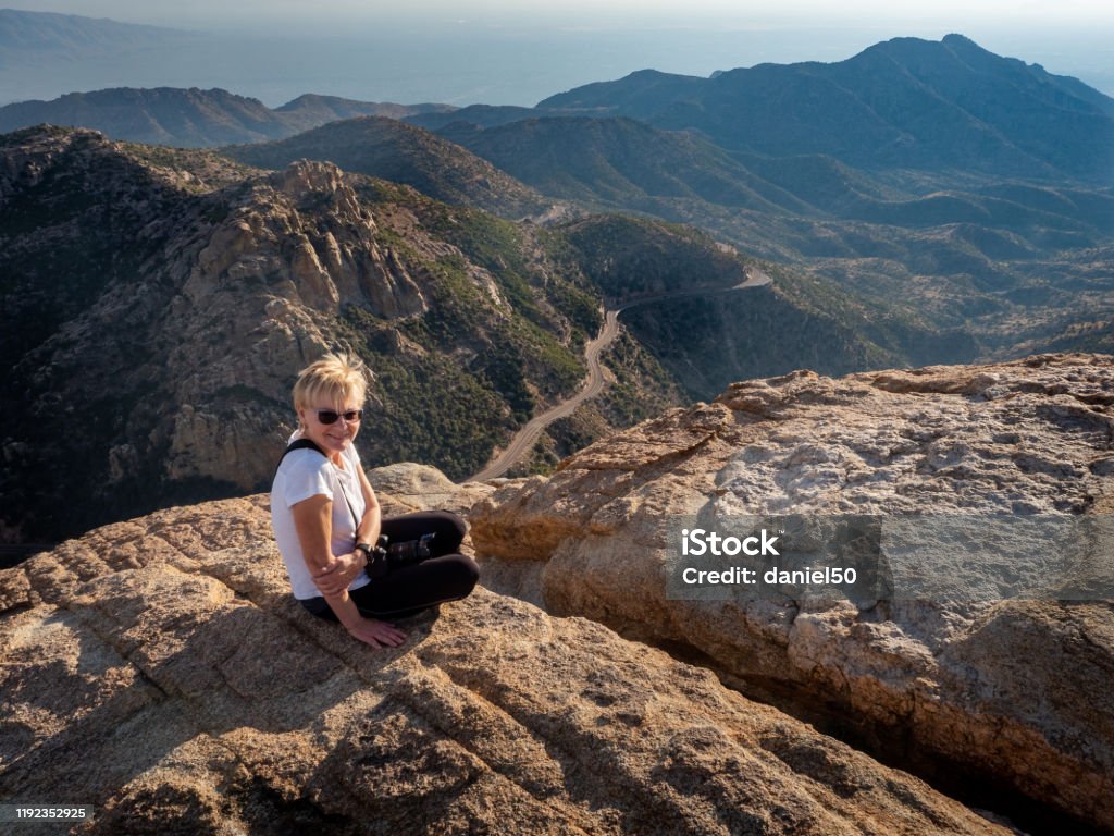 Women sitting on mountain in Mt Lemmon Mature women in Mount Lemmon  in Catalina Mountains, tucson, arizona Arizona Stock Photo