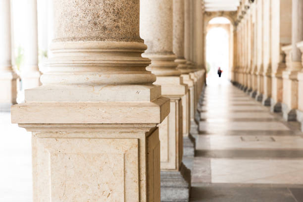 istock Colonnade, row of classical stone columns, background with copy spaced 1192354221