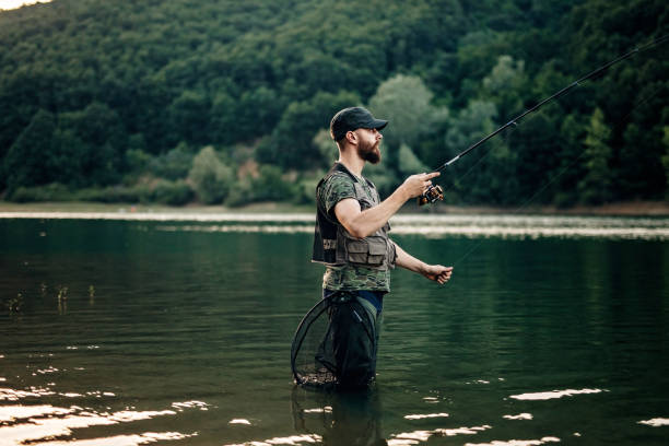 istock Young man fishing 1192355376