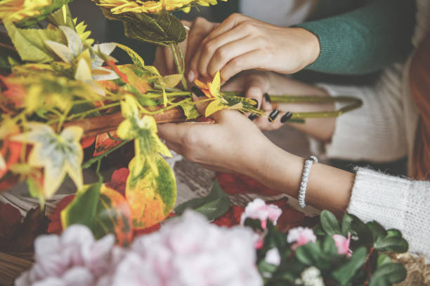istock Two unrecognizable young women making flower arrangements for decoration 1192355701