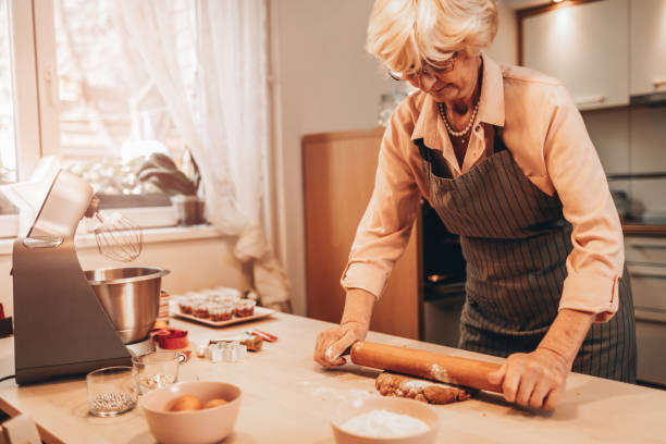 istock Senior Woman Making Gingerbread Cookies 1192355797