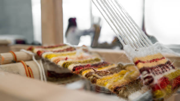 クラフトマンシップの背景。ヴィンテージ織機に織るプロセス。ウールをクローズアップした伝統的なヴィンテージ織り手織りのディテール。クラフトマンシップの背景。伝統的な古い織機� - rarity ストックフォトと画像