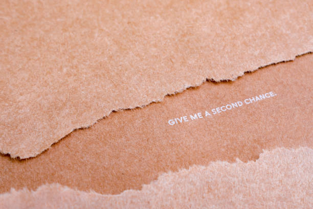 istock Wastepaper background. Reuse background. Words on craft paper. Give me a second chance. World resources concept. Reusing paper-based products. Ecological problems. Reusing concept 1192355849