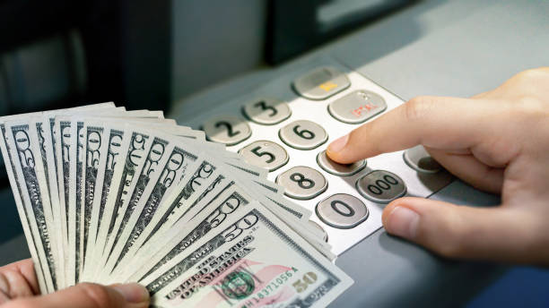 istock withdrawal process dollar and password entry from bank atm 1192358256