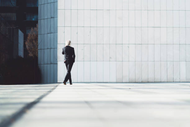 istock Businessman wearing a suit and tie making a phone call outside 1192359043