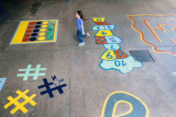 Schoolgirl playing in schoolyard at recess
