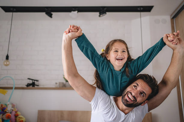 istock Father and a young daughter having fun at home 1192363691