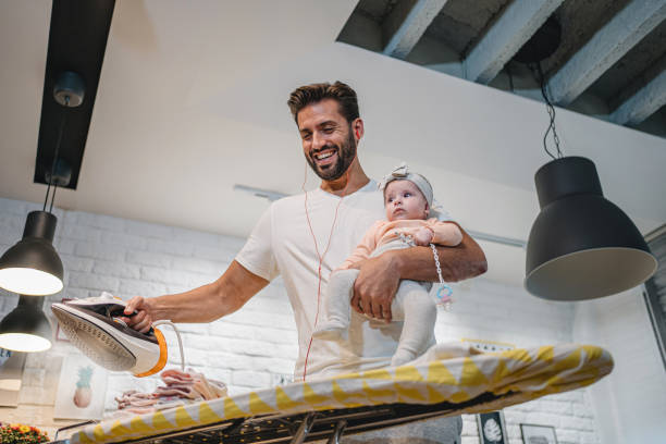istock Handsome father doing house chores with a baby 1192363909