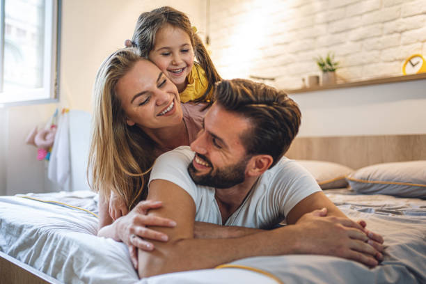 istock Gorgeous family having fun in bedroom 1192364884