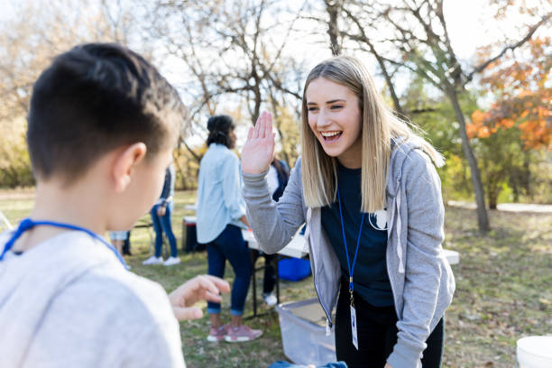Community outreach volunteer coordinator greets young volunteer