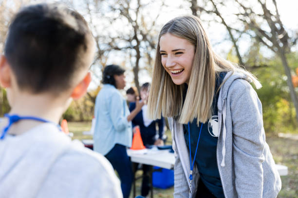 istock Cheerful female volunteer talks with young volunteer 1192366440
