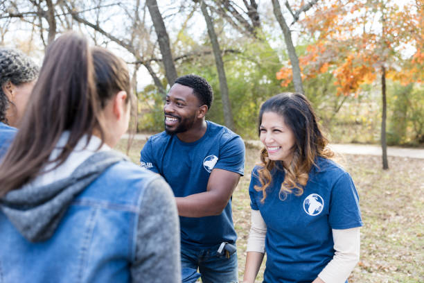 istock Cheerful woman greets volunteers during cleanup event 1192366443