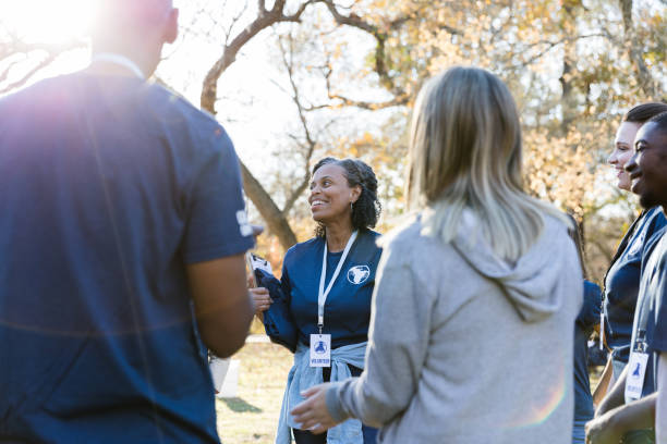 istock Mature female volunteer coordinator talks with volunteers 1192366463