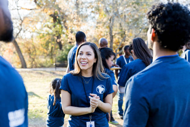 istock Confident female volunteer talks with friends 1192366473