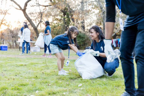 istock Mom and daughter pick up garbage during cleanup event 1192366502