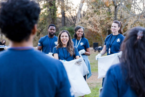 istock Neighbors picking up garbage during community cleanup 1192366510