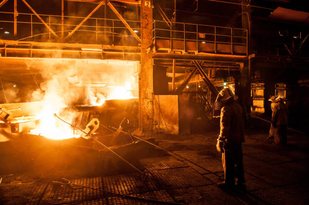 istock Steelworkers when pouring liquid titanium slag from arc furnace 1192368473