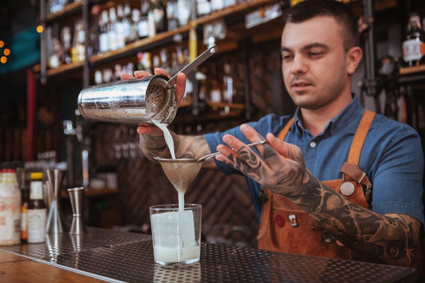 istock Handsome male bartender making cocktails 1192368568