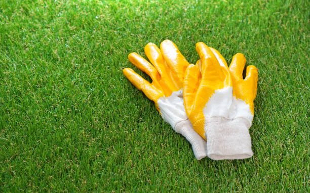 istock Protective gloves lie on the artificial grass lawn 1192368703