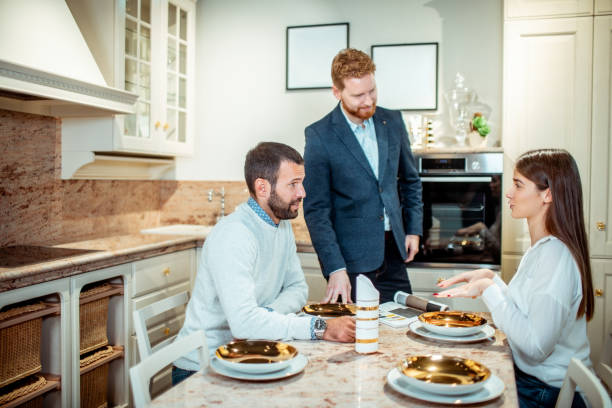 istock Young couple getting advice for kitchen renovation from a sales assistant in a kitchen equipment and accessories store 1192369402