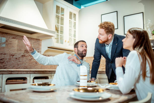 istock A male explaining his decor and functionality idea to his wife and sales rep in a kitchen appliances shop 1192369432