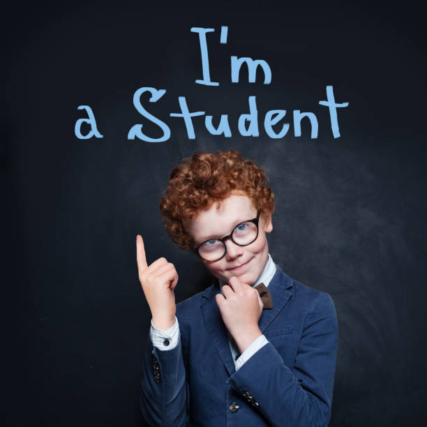 istock Smart kid pointing up. Back to school concept 1192369518