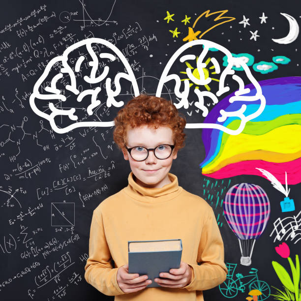 istock Smart little boy on blackboard background portrait 1192369571