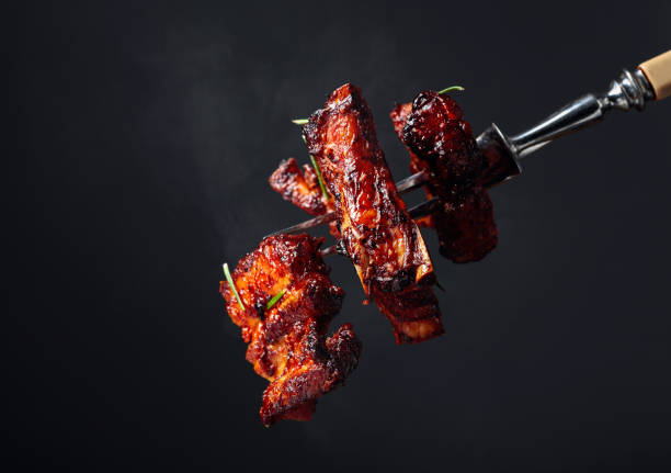 istock Grilled pork belly with rosemary on a fork. 1192371683