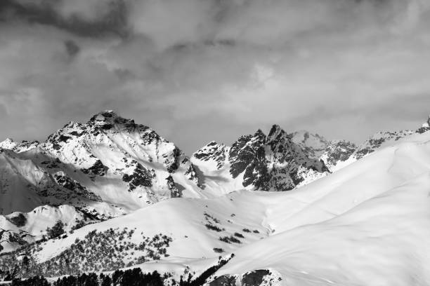 istock Snowy off-piste slope and mountains in clouds 1192377916
