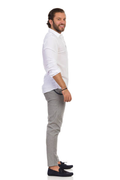 istock Side View Of Elegant Man Standing And Looking At Camera 1192383830