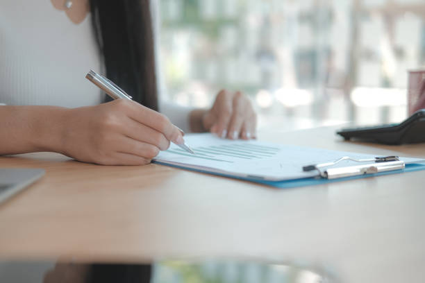 istock businesswoman working with document. startup woman analyzing financial performance. student studying doing assignment 1192383855