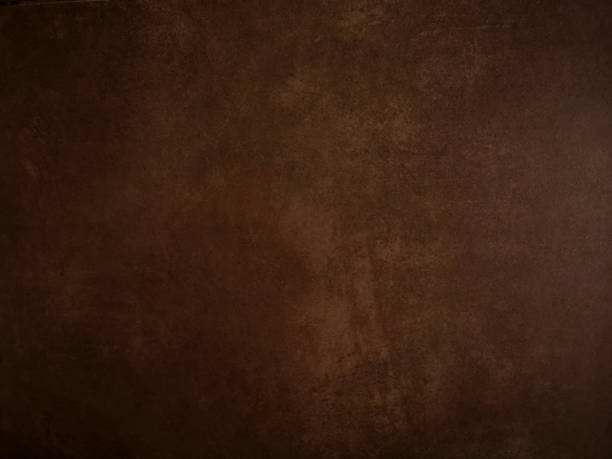 istock old Brown background gradient color paint on cement wall space for copy write rough texture material 1192395075