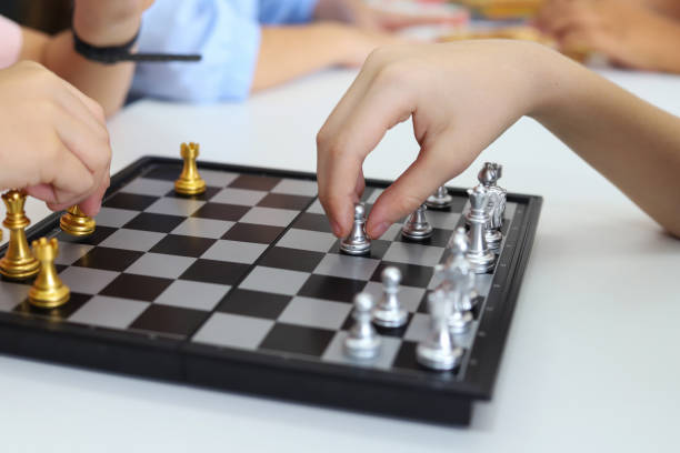istock Kids playing chess in classroom 1192396731