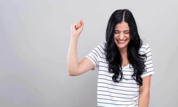 istock Young woman making a yay gesture 1192398643