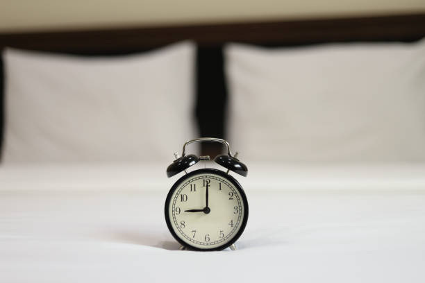 istock Retro black alarm clock on the bed 1192423083