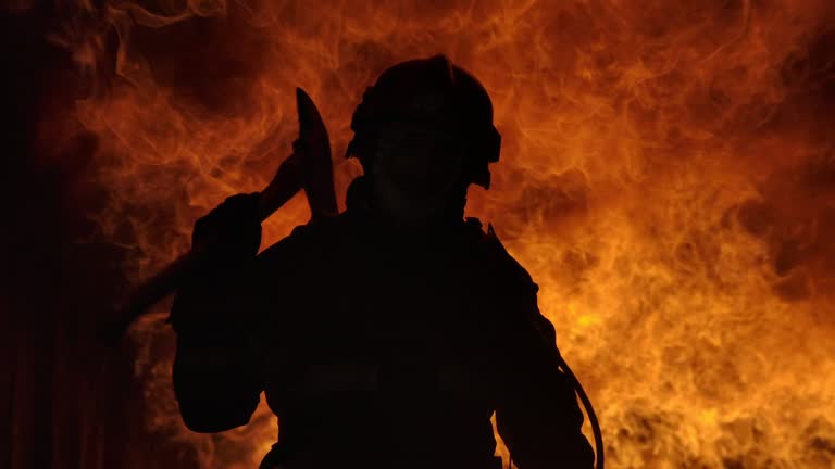 Firefighter working. Fire is Raging. In Slow Motion.