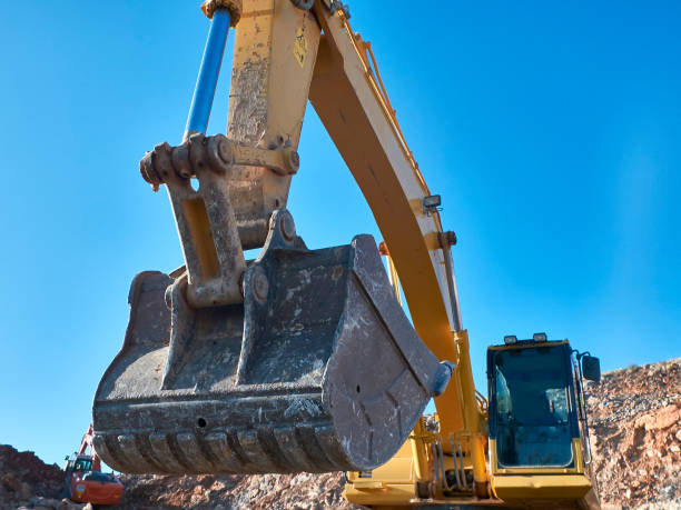 istock Excavator scoop during road construction on the rocky soils 1192425531