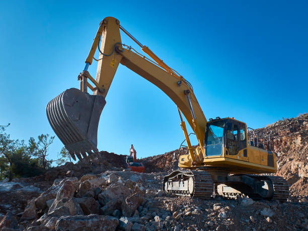 istock Excavator is moving a rock boulders during road construction on the rocky soils 1192425553