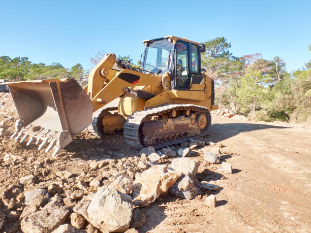 istock Bulldozer is boulders during road construction works 1192426500