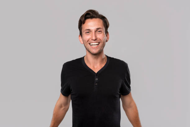 istock Happy young man in a black tee smiling looking at the camera 1192430921