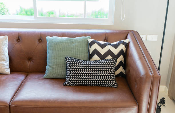 istock Brown leather sofa with graphic pattern pillow in elegant living room interior. 1192431079