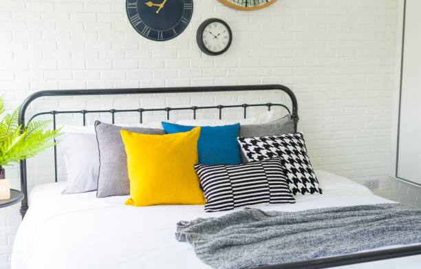 istock yellow and blue pillows on bed in modern bedroom 1192431514