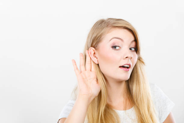 istock Woman putting hand ear to hear better 1192435044