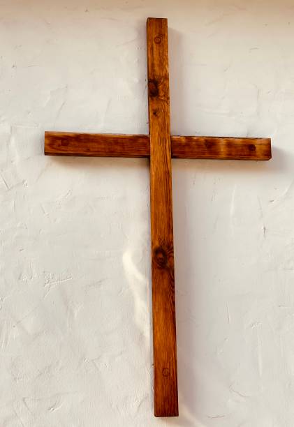 istock Wooden crucifix on white wall 1192437396