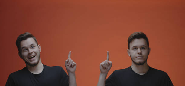 istock Goofy young man popping up and pointing up 1192444021