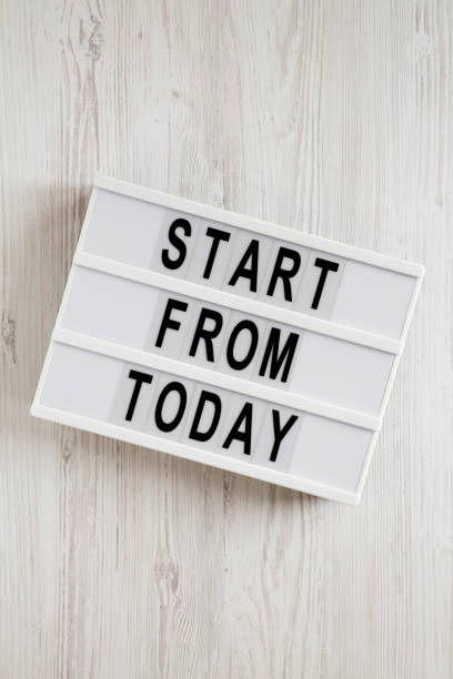 istock 'Start from today' words on a modern board on a white wooden background, top view. Overhead, from above, flat lay. Close-up. 1192445075